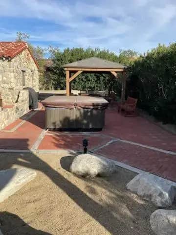 a hot tub and a gazebo on a patio at Miracle Springs Resort and Spa in Desert Hot Springs