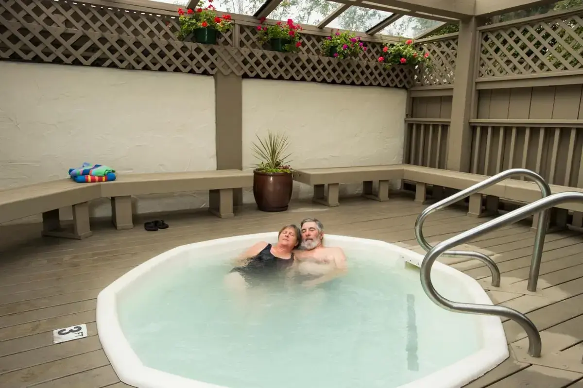 a man and woman in a jacuzzi in a hot tub at Mission Inn in Santa Cruz