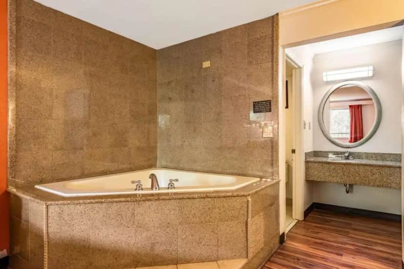 a large bath tub in a bathroom with a mirror at Motel 6-Gatlinburg, TN - Smoky Mountains in Gatlinburg