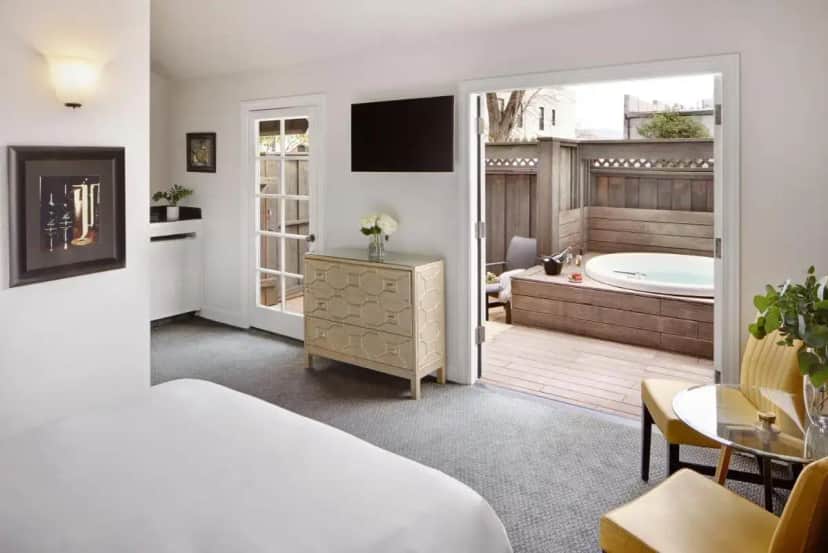 a hotel room with a bed and a tub at Mount View Hotel & Spa in Calistoga