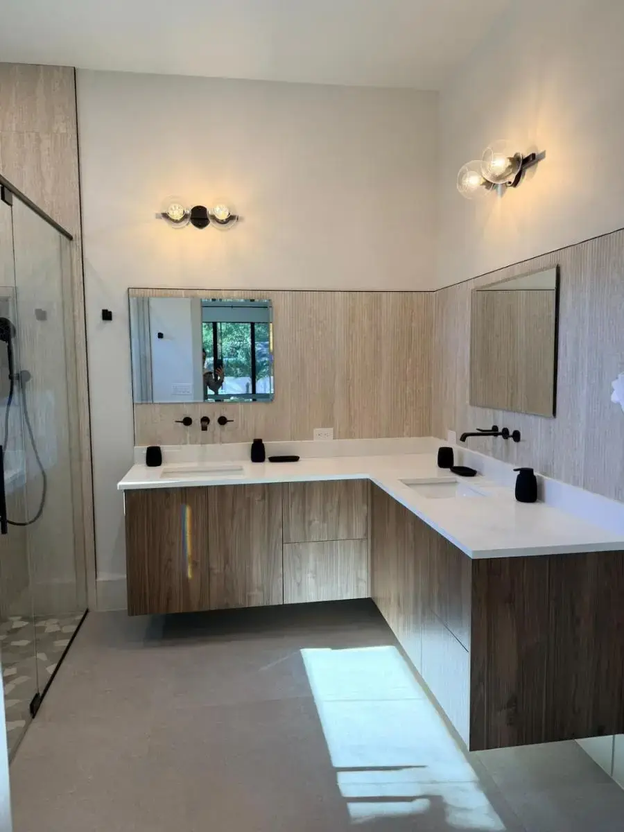 a bathroom with two sinks and a mirror at New Upscale & Modern Heated Pool Home in Walkable Downtown! in Sarasota