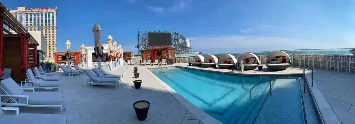 a large swimming pool on a building with chairs at Nobu Hotel Atlantic City - A Caesars Rewards Destination in Atlantic City