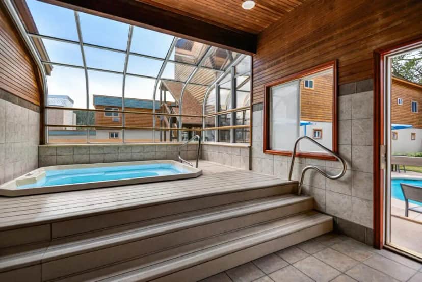 a hot tub in a room with a window at Nordic Lodge in Steamboat Springs