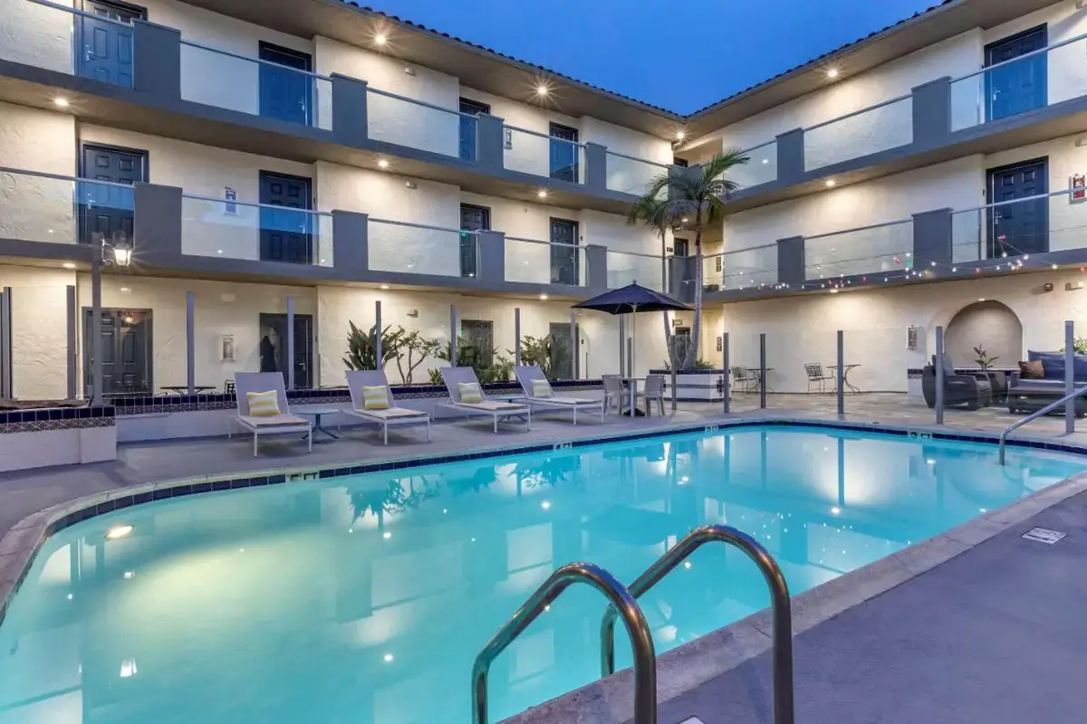 a swimming pool in a hotel with chairs and a building at Comfort Inn San Diego Old Town in San Diego