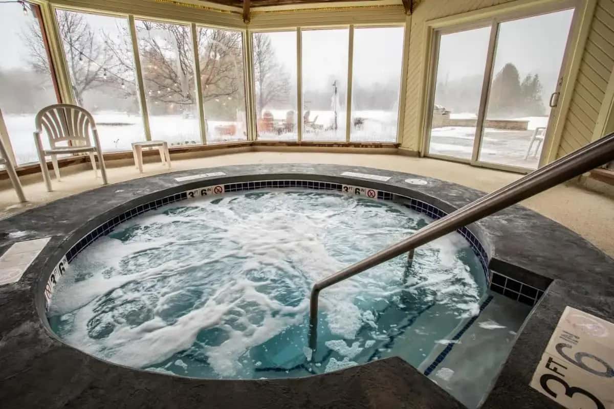 a jacuzzi tub in a house with snow at Open Hearth Lodge in Sister Bay