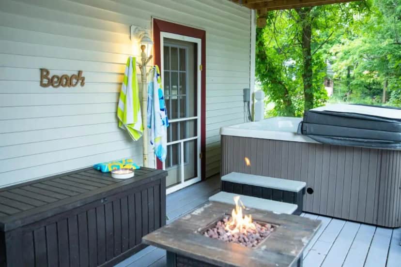 a deck with a fire pit and a hot tub at osheehan hacienda in LaPorte