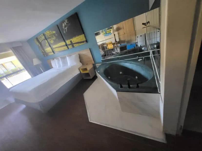 a bathroom with a large sink and a bed at Park Inn by Radisson, Attalla-Gadsden in Attalla