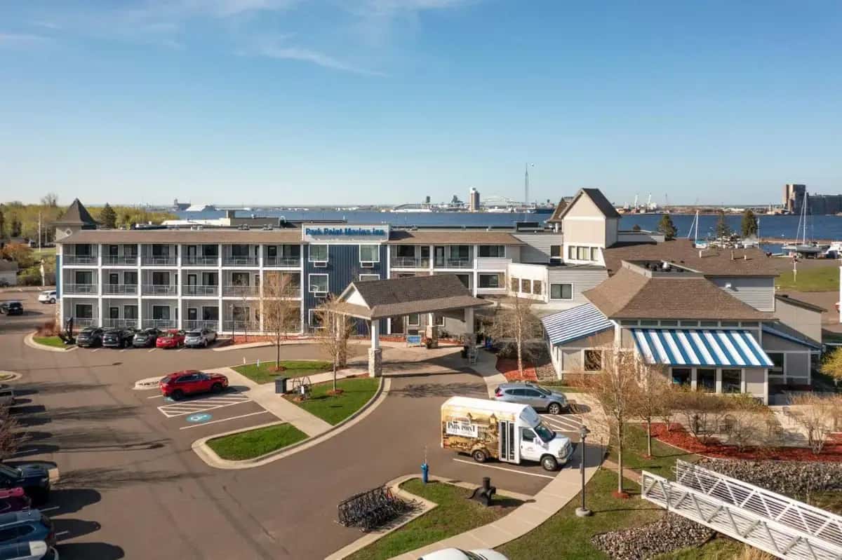 a city with a building and a street with a food truck at Park Point Marina Inn in Duluth