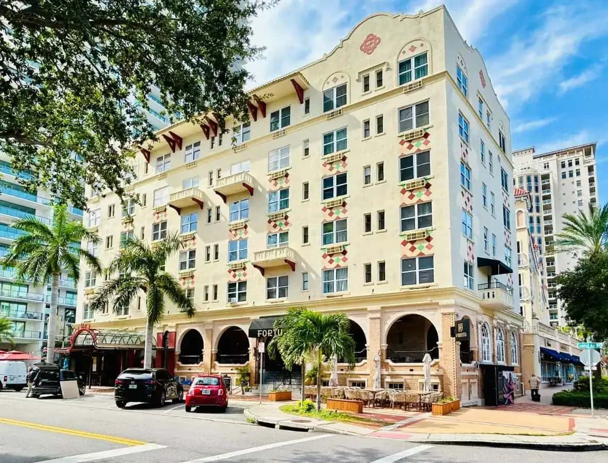 a large building on a city street with palm trees at Ponce De Leon Hotel in St. Petersburg