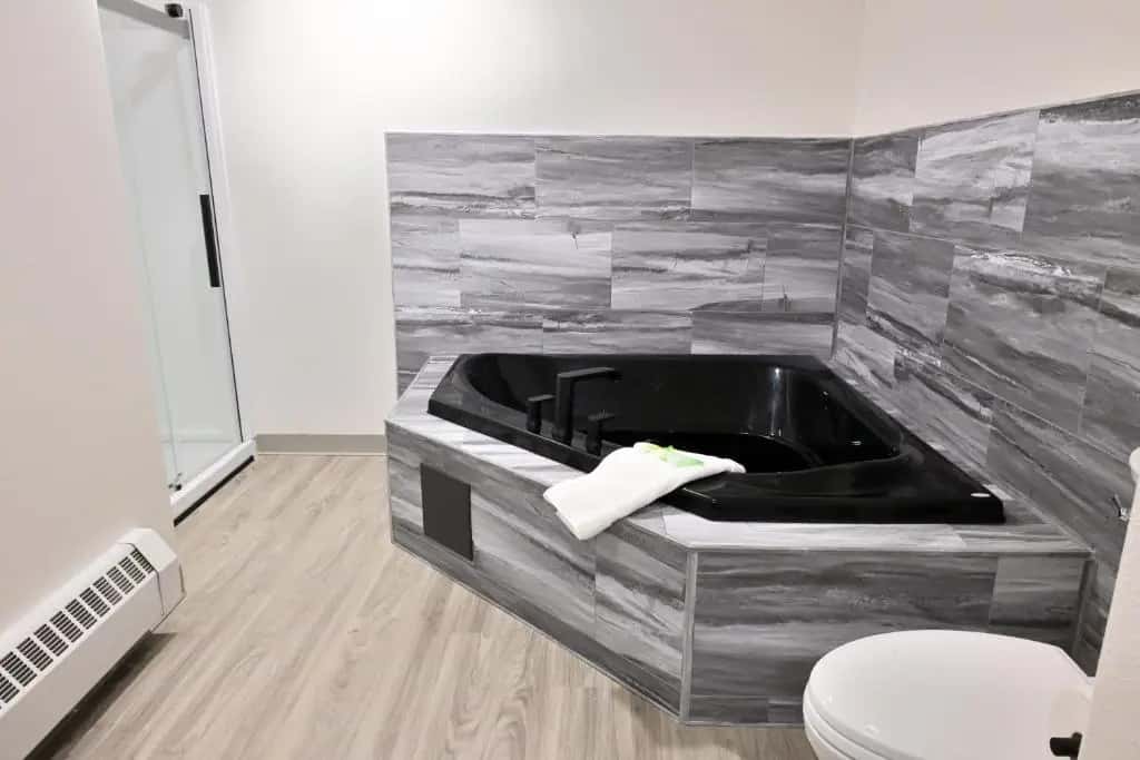 Private in-room jacuzzi tub in the Deluxe Queen Suite at Puffin Inn Of Anchorage