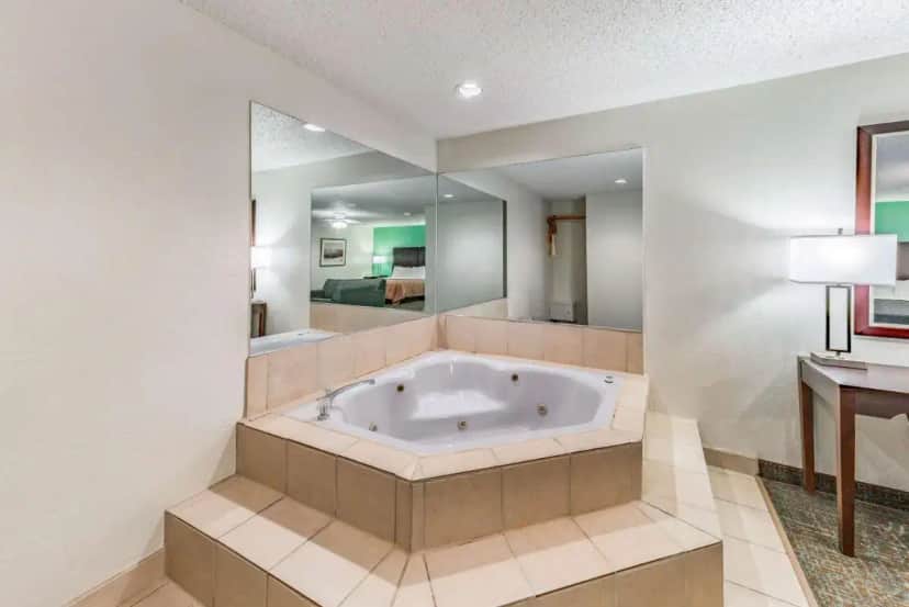 a large bathroom with a tub in a room at Quality Inn Allen - Plano East in Allen