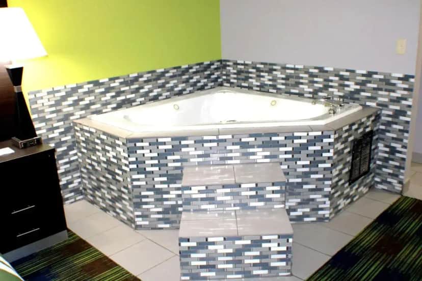 a bathroom with a jacuzzi tub in a room at Quality Inn & Suites Bedford West in Bedford