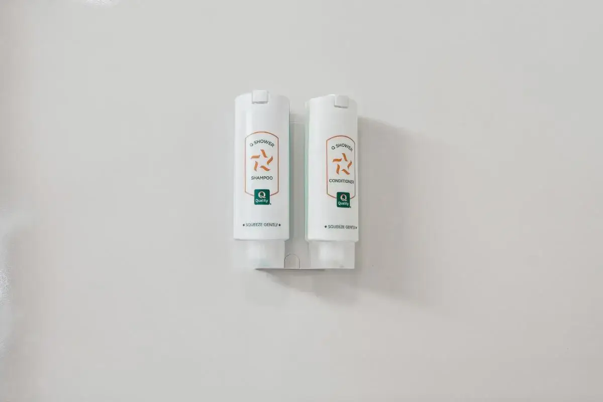 two white bottles of shampoo on a white background at Quality Inn & Suites Dawsonville in Dawsonville