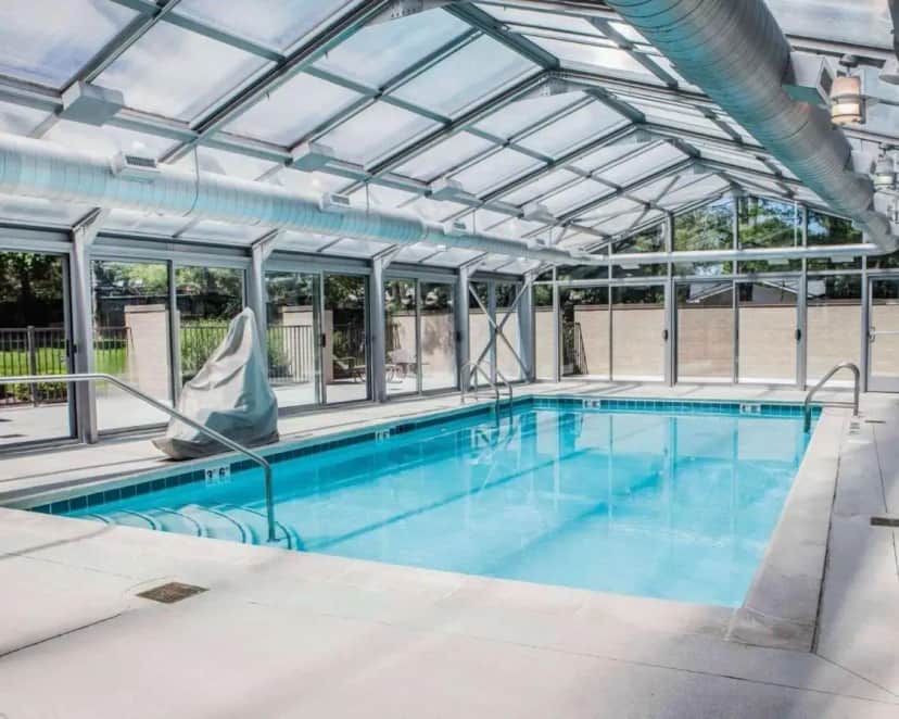 a large swimming pool with a glass roof at Quality Inn & Suites Peoria North in Peoria