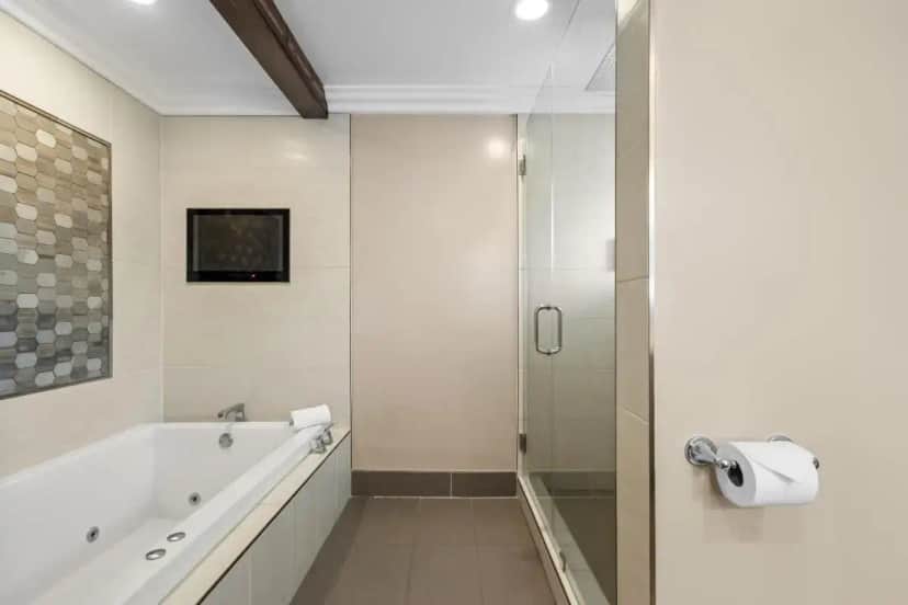a bathroom with a bath tub and a shower at Quality Inn & Suites Santa Maria in Santa Maria