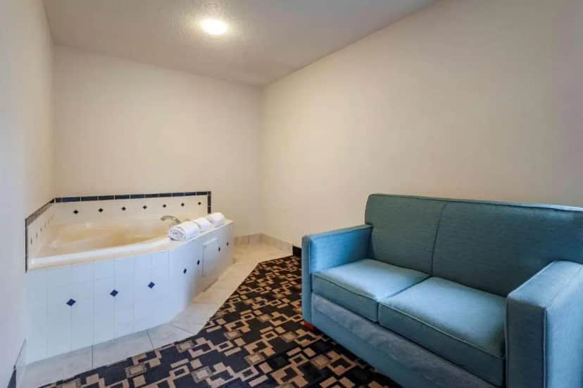 a living room with a tub and a couch at Quality Inn Redgranite in Redgranite