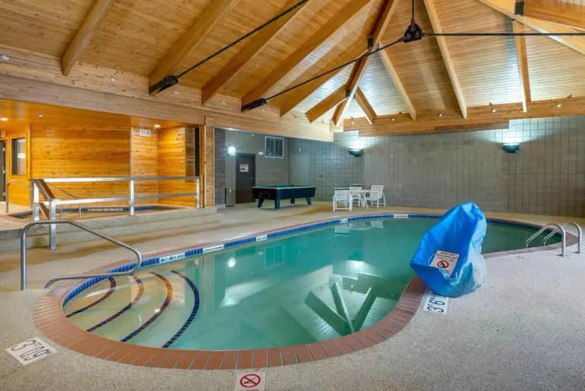 a swimming pool in a large room with a pool at Quality Inn St Cloud West in Saint Cloud