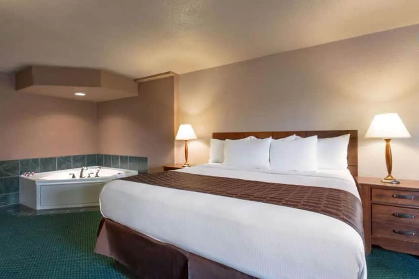 Private in-room jacuzzi tub in the King Suite with Jetted Tub - Non-Smoking at Ramada by Wyndham Bismarck