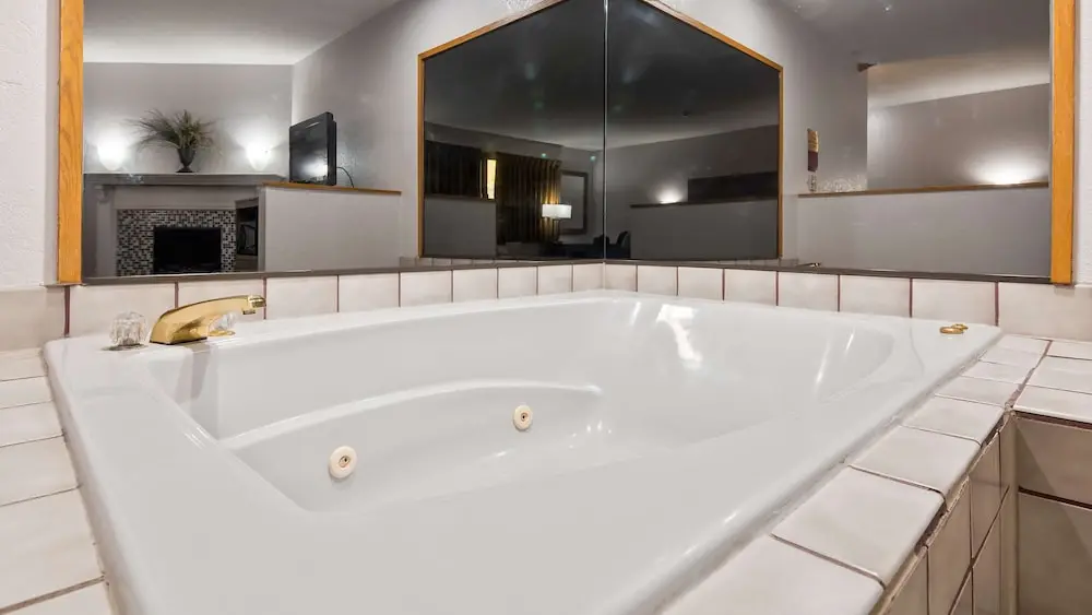 Private in-room jacuzzi tub in the Suite, 1 King Bed, Non Smoking, Jetted Tub at Ramada by Wyndham Cedar Rapids South