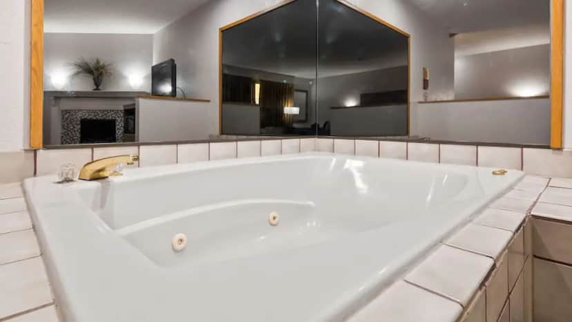 Private in-room jacuzzi tub in the Suite, 1 King Bed, Non Smoking, Jetted Tub at Ramada by Wyndham Cedar Rapids South