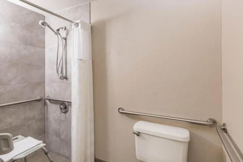 a bathroom with a toilet and a shower at Ramada by Wyndham Platte City KCI Airport in Platte City