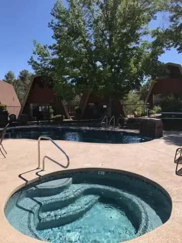 a hot tub in a yard with a tree at Red Agave Resort in Sedona