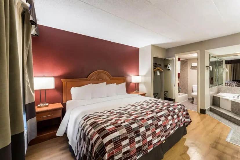 a hotel room with a bed and a bathroom at Red Roof Inn Morton Grove in Morton Grove