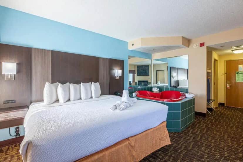 a hotel room with a large bed and a bathroom at River Bend Inn - Pigeon Forge in Pigeon Forge