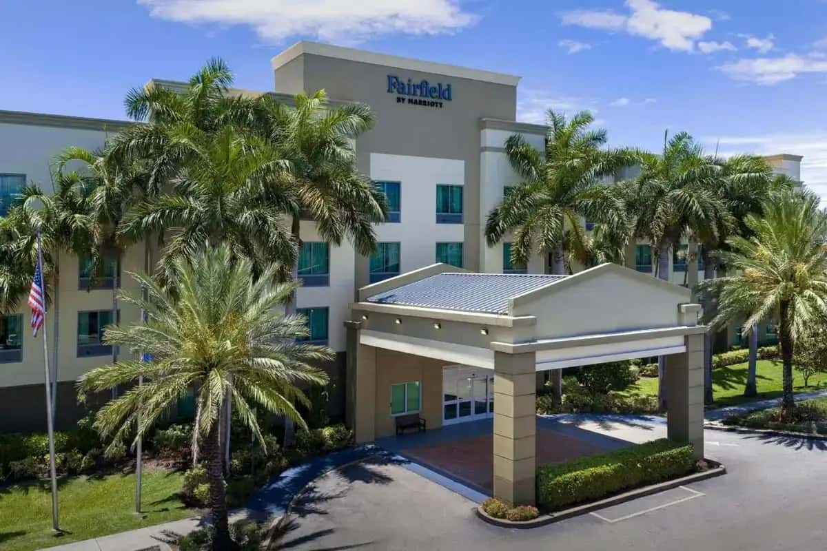 an office building with palm trees in front of it at Fairfield Inn & Suites Fort Lauderdale Airport & Cruise Port in Dania Beach