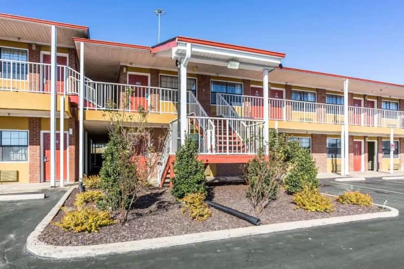 a apartment building with trees in front of it at Rodeway Inn & Suites Smyrna - Nashville Area in Smyrna
