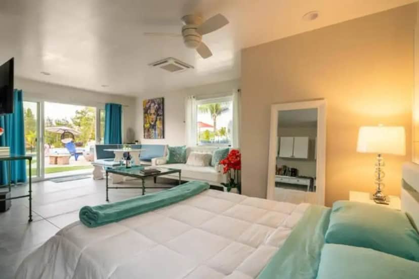 a bedroom with a large bed and a living room at Romantic Villa in Pool Oasis Walk to Wineries in Temecula
