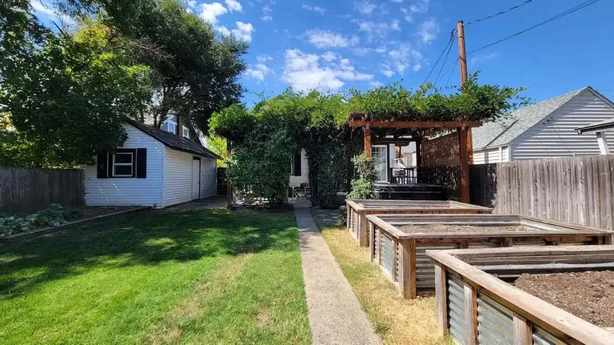 a backyard with a wooden fence and a house at Rosewood Landing by WanderLodges - Hot tub - Sauna in Medford