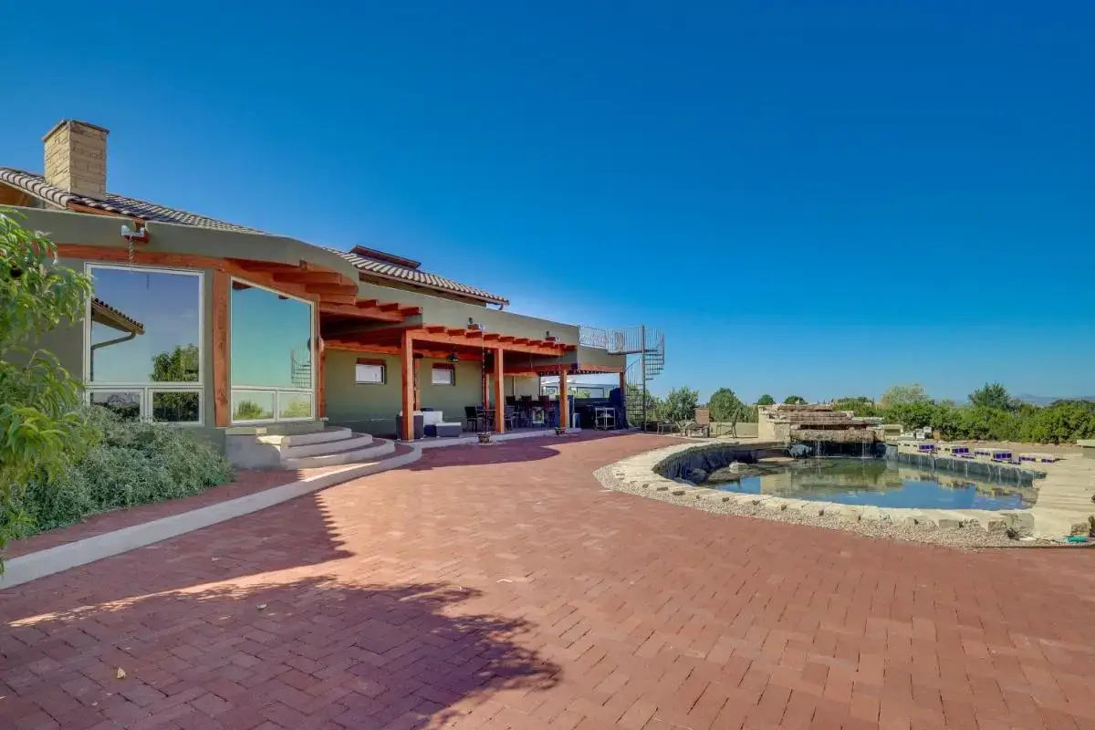 a brick walkway next to a building with a pool at Scenic Santa Fe Vacation Rental w/ Views + Hot Tub in Santa Fe