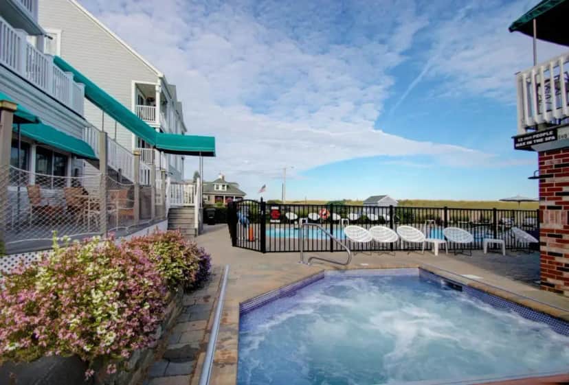 a hot tub on a patio next to a building at Sea Cliff House Motel in Old Orchard Beach