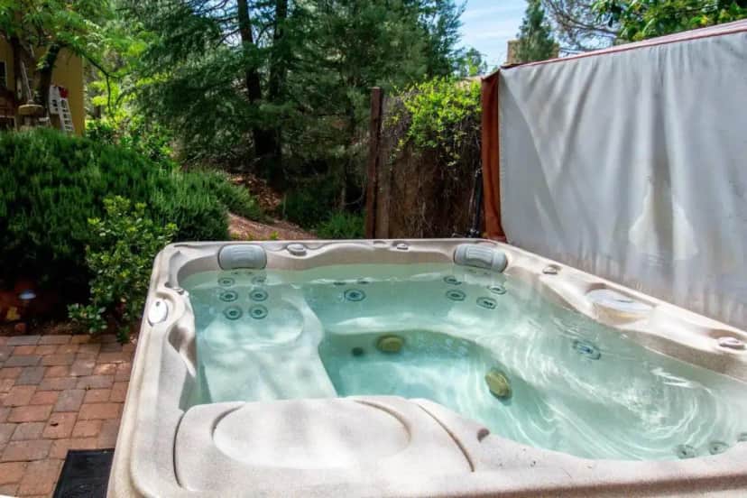 a jacuzzi tub in the backyard of a house at Sedona Wellness Casita with Hot Tub, Outdoor Sauna & Private Courtyard in Sedona