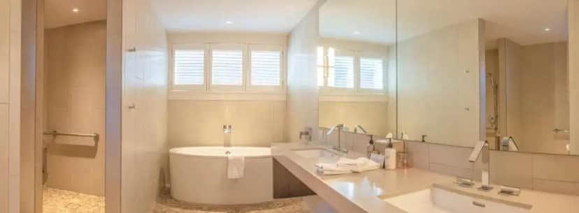 a bathroom with a sink and a toilet and a mirror at SENZA Hotel in Napa