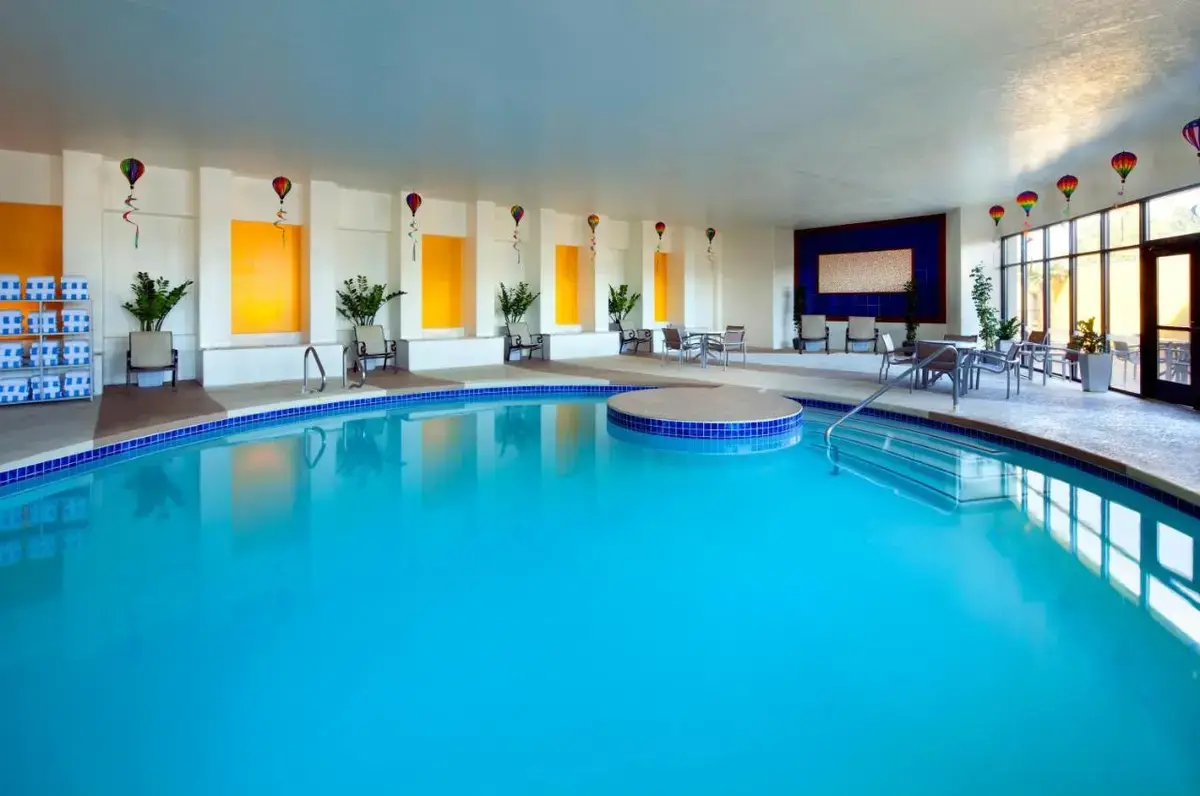 a large swimming pool in a hotel lobby at Sheraton Albuquerque Uptown by Marriott in Albuquerque