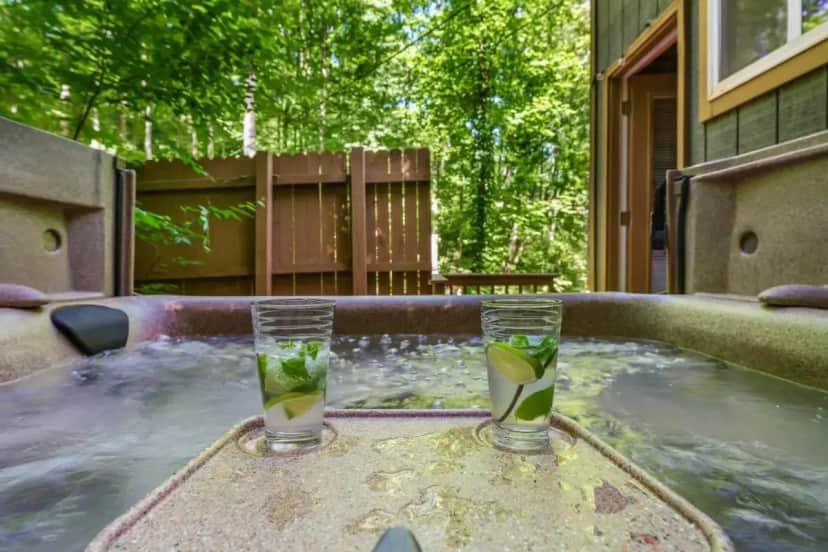 two glasses sitting on top of a hot tub at Silverbell, Secluded Nature Views, Hot Tub, WiFi, King Bed, Firepit in Gatlinburg