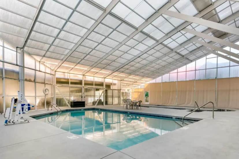 a large swimming pool with a glass ceiling at Sleep Inn & Suites near Sports World Blvd in Gatlinburg