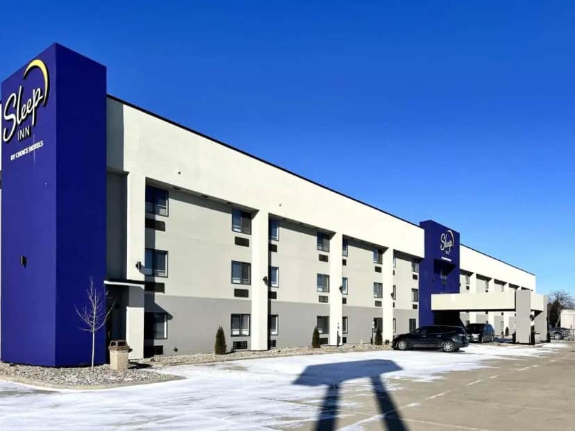 a building with a car parked in front of it at Sleep Inn Champaign North - Urbana in Champaign