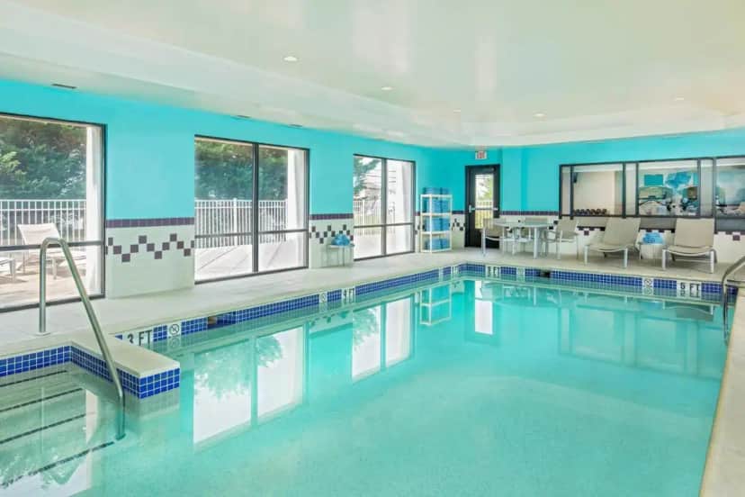 a swimming pool with blue walls and windows at SpringHill Suites by Marriott Hershey Near The Park in Hershey