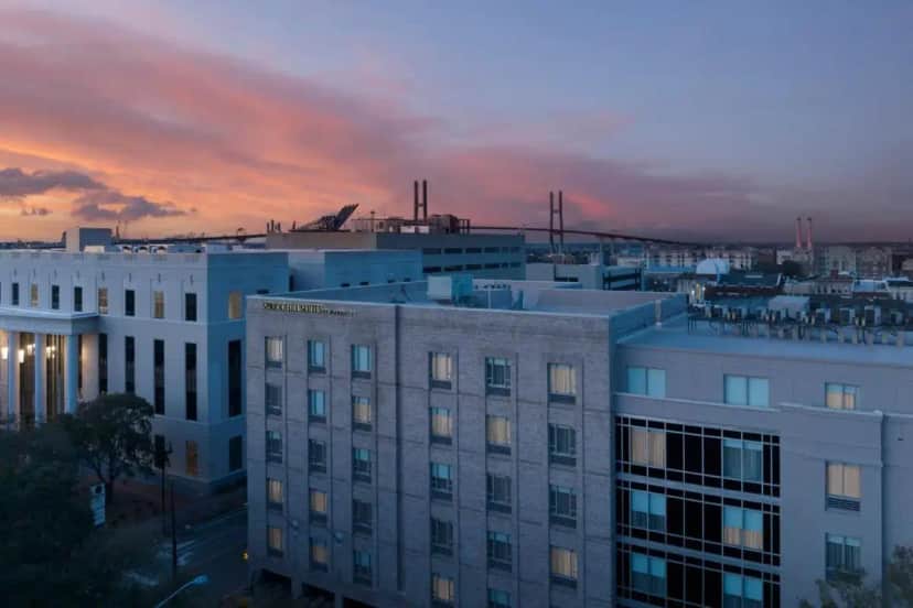 a view of a building with a sunset in the background at Springhill Suites by Marriott Savannah Downtown Historic District in Savannah