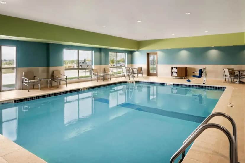a large pool with blue water in a hotel room at Holiday Inn Express & Suites - West Des Moines - Jordan Creek by IHG in West Des Moines
