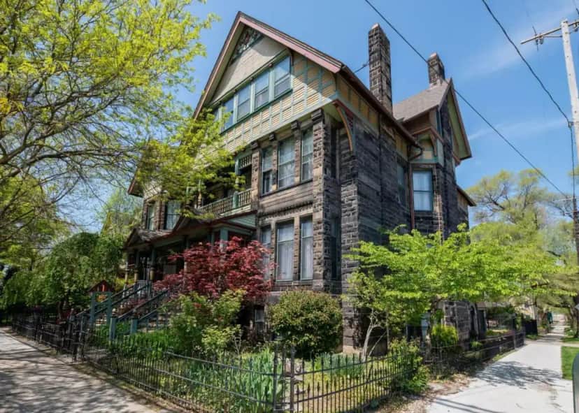 an old house with a fence in front of it at Stone Gables Inn in Cleveland