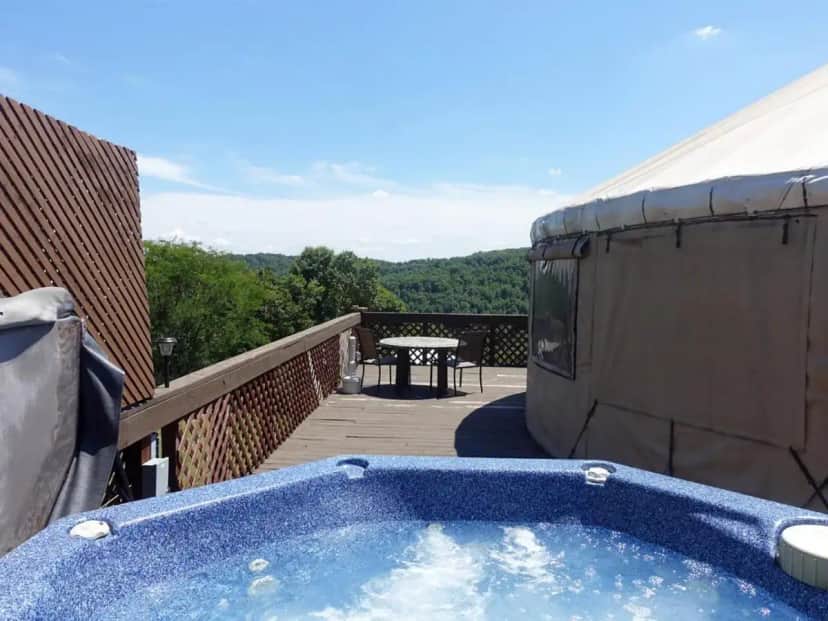 a blue hot tub on a balcony with a table at StoneWind Retreat in Chester