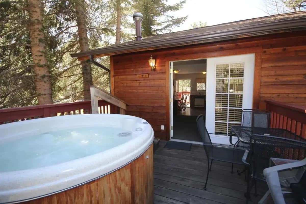 a hot tub on the deck of a cabin at Streamside on Fall River in Estes Park