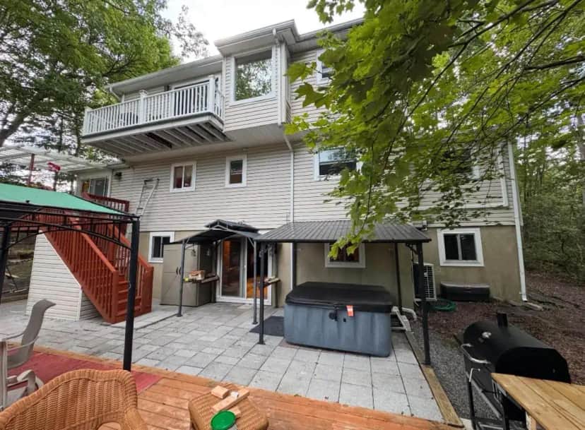 a house with a patio with a large trash can
