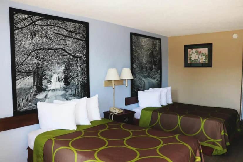 a hotel room with two beds and a large picture at Super 8 by Wyndham Clarksville East in Clarksville