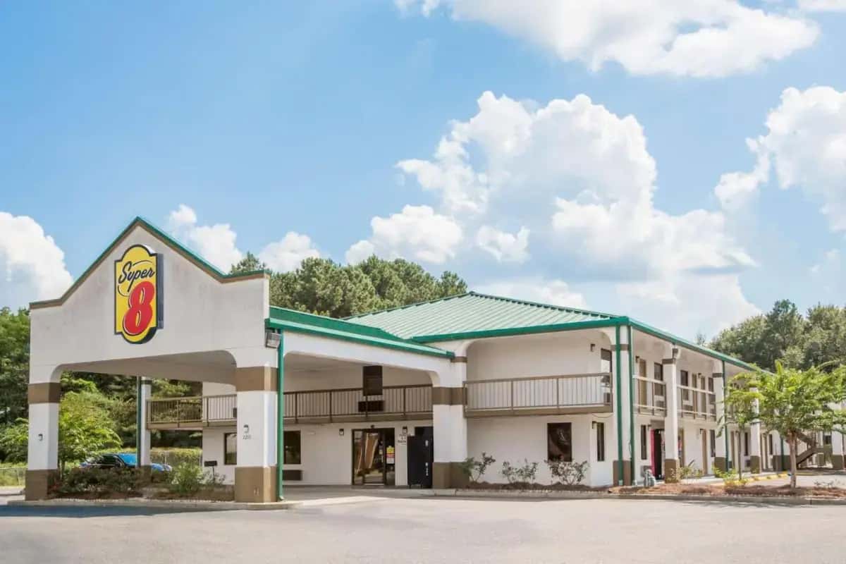 a hotel exterior with a gas station at Super 8 by Wyndham Dothan in Dothan