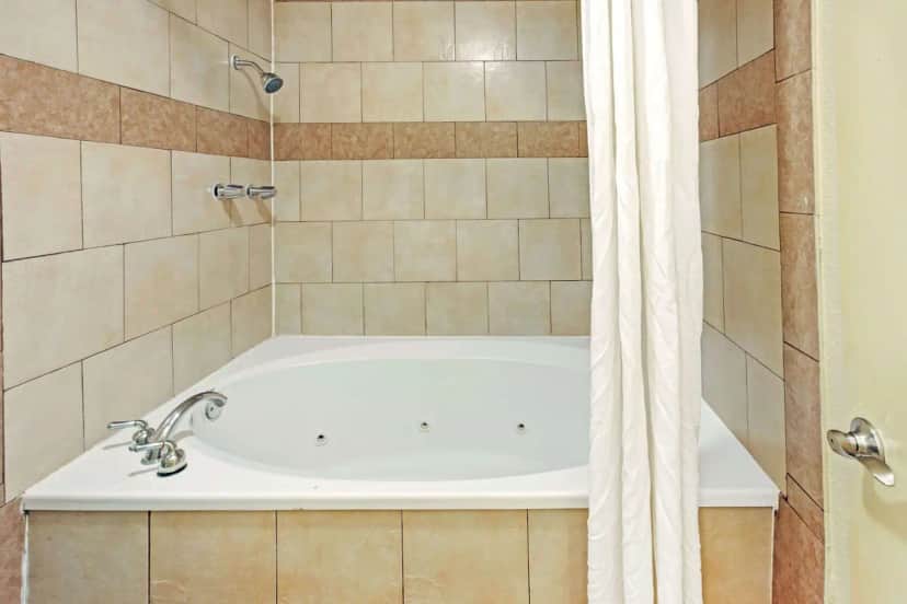 Private in-room jacuzzi tub at Super 8 Dallas East Near Fair Park Downtown